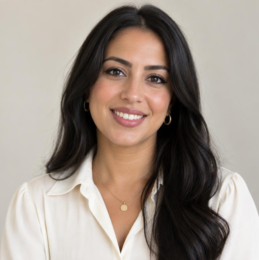Portrait of a young woman with dark hair smiling